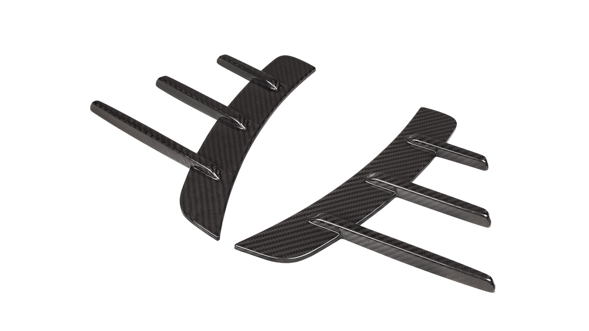 Black carbon fiber fin-like appendages curve inward, resembling aerodynamic car accessories, set against a white background.