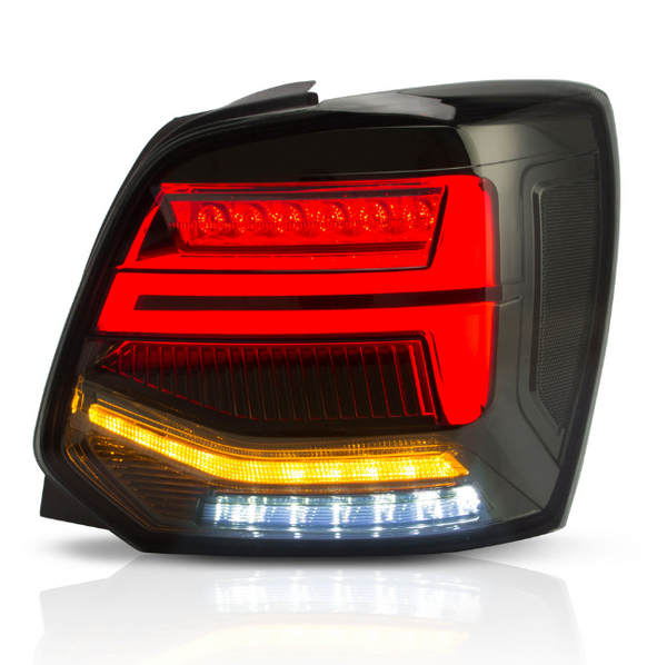 A car taillight assembly displays glowing red, amber, and white LED segments, set against a dark background, highlighting its sleek, modern design with reflective surfaces.