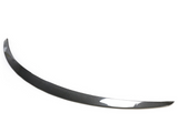 A curved carbon fiber car spoiler rests against a plain white background, showcasing a sleek and aerodynamic design with a glossy finish.