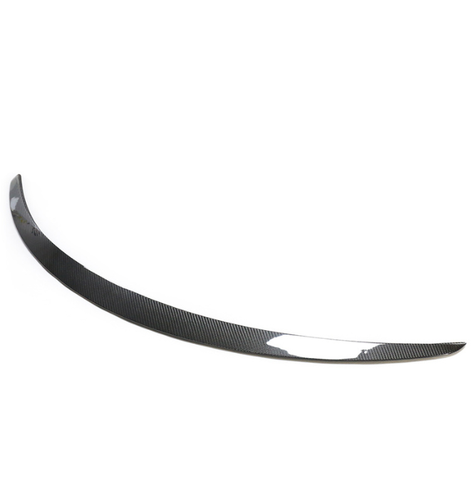 A curved carbon fiber car spoiler rests against a plain white background, showcasing a sleek and aerodynamic design with a glossy finish.