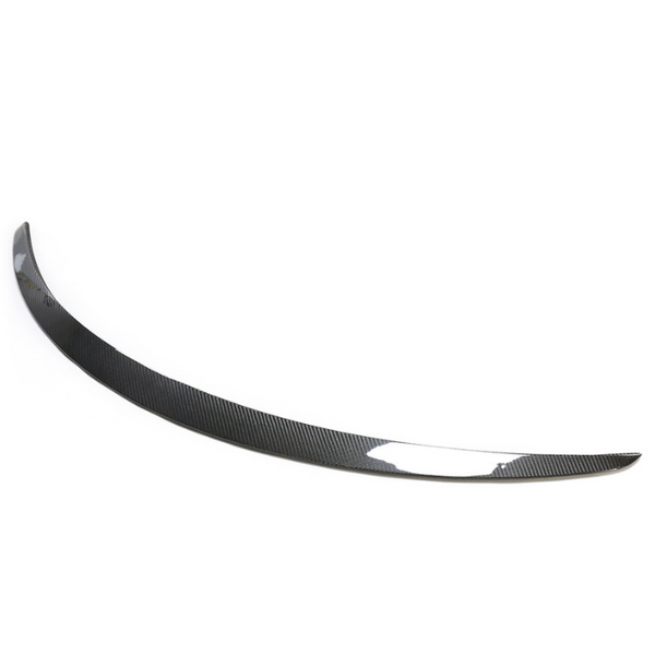 A curved carbon fiber car spoiler rests against a plain white background, showcasing a sleek and aerodynamic design with a glossy finish.