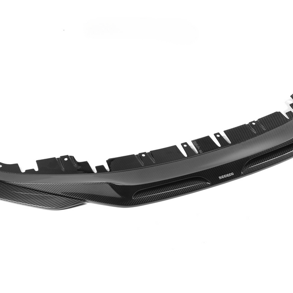 A carbon fiber car bumper with vent openings and mounting holes, positioned on a white background. The brand name "SODEGO" is visible on the bumper.