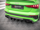 A green Audi RS 3 displays a Maxton Design license plate. The car is parked on a patterned floor indoors. The license plate reads: 