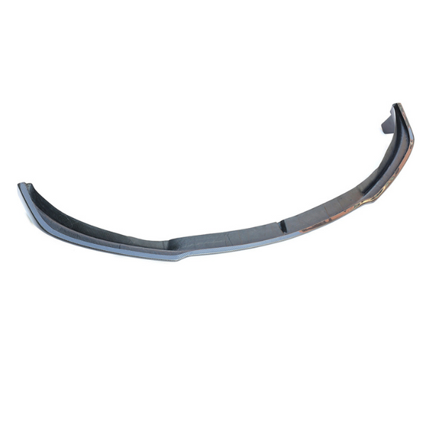 Curved car bumper, resting on a white background, designed for a sleek fit on the front of a vehicle, emphasizing aerodynamics and style.