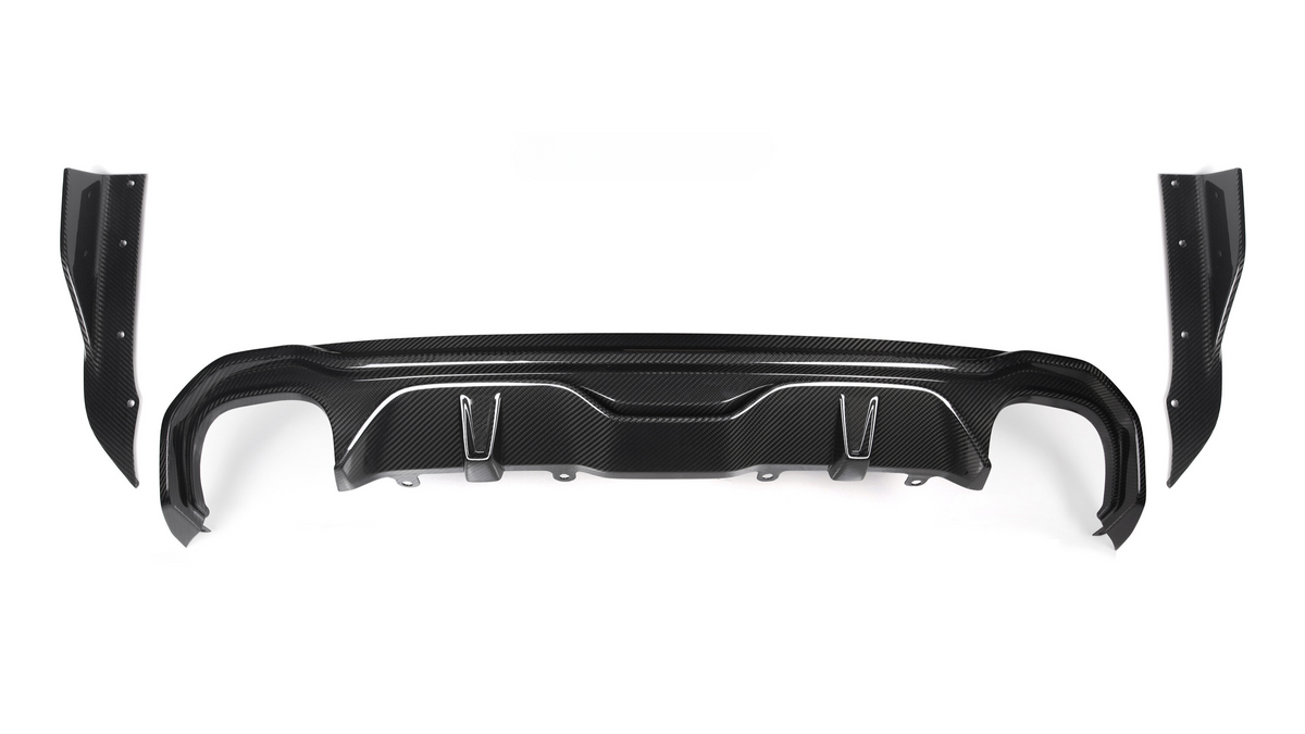 A black carbon fiber car bumper diffuser, featuring curved and angular design elements, is positioned against a plain white background. It includes attachment points and side wing pieces on either end.