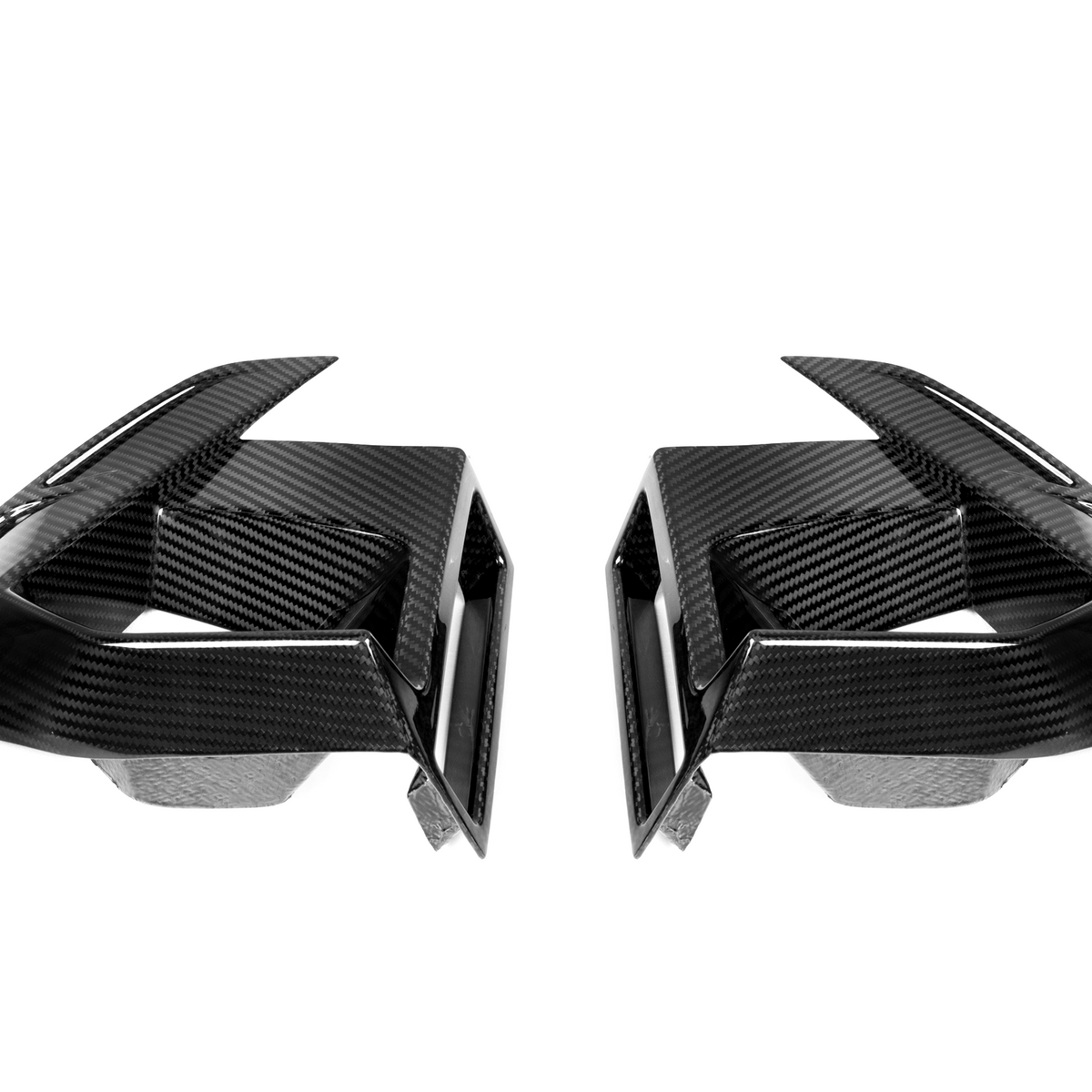 Two symmetrical, black carbon fiber air vents with sharp angles, facing each other, against a plain white background.