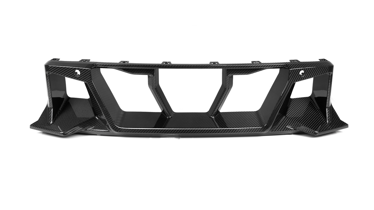 A carbon fiber car diffuser with angular vents is positioned on a white background, emphasizing its sleek, aerodynamic design intended for enhanced vehicular performance and aesthetic.