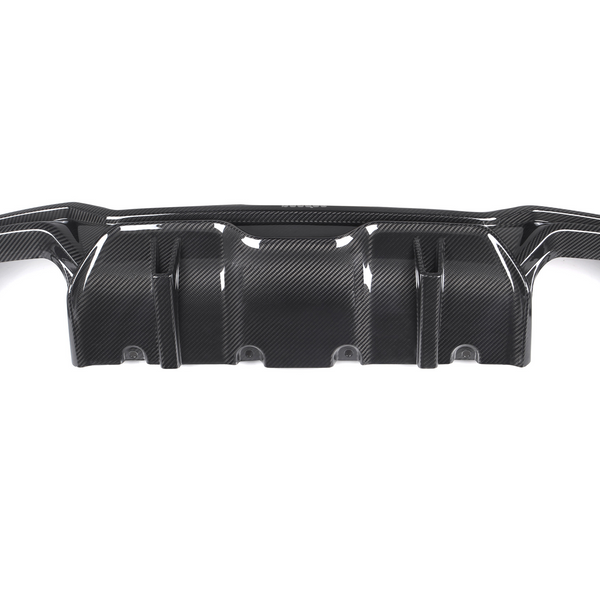 A black carbon fiber car diffuser with a textured surface, positioned centrally with two smaller side pieces detached, set against a plain white background.
