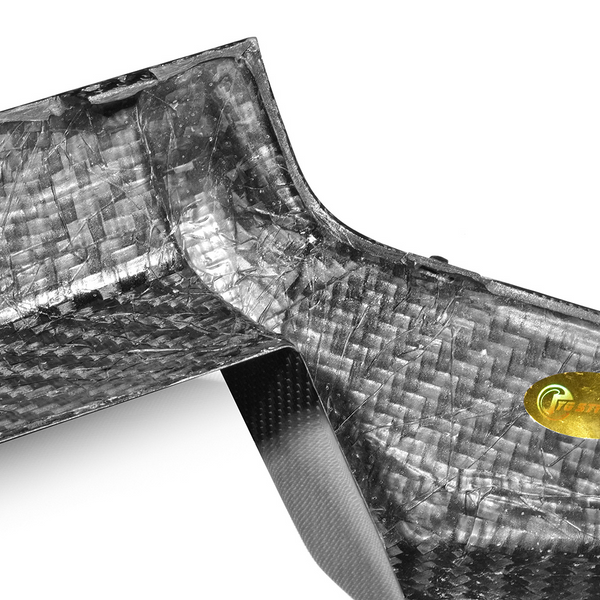 Close-up of a woven carbon fiber surface, showcasing a glossy texture. A small gold logo is visible on the right, featuring stylized text: "Craste Carbon." The background is white.