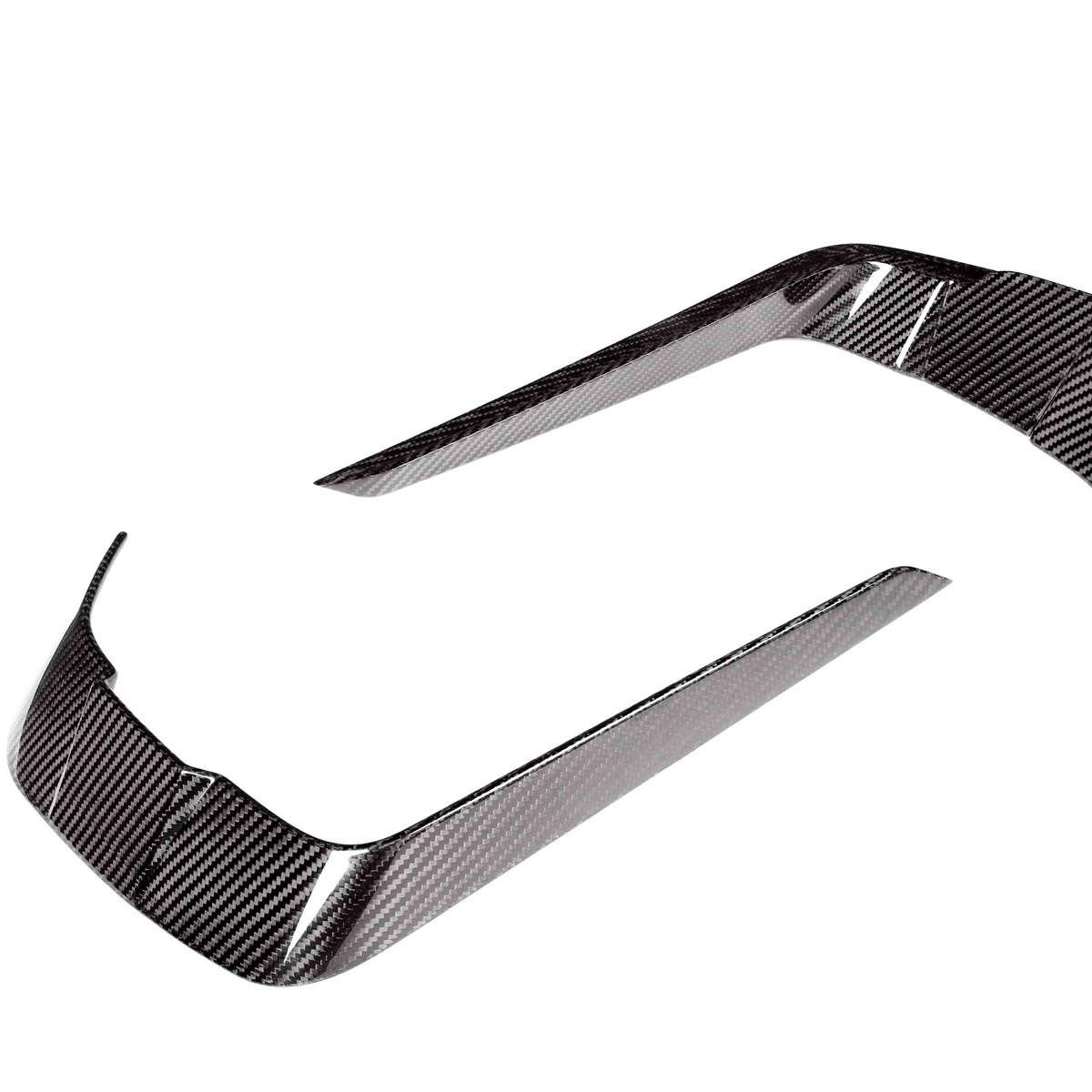 Two curved carbon fiber trim pieces, reflecting light, positioned apart on a white background. They are designed for vehicle detailing.