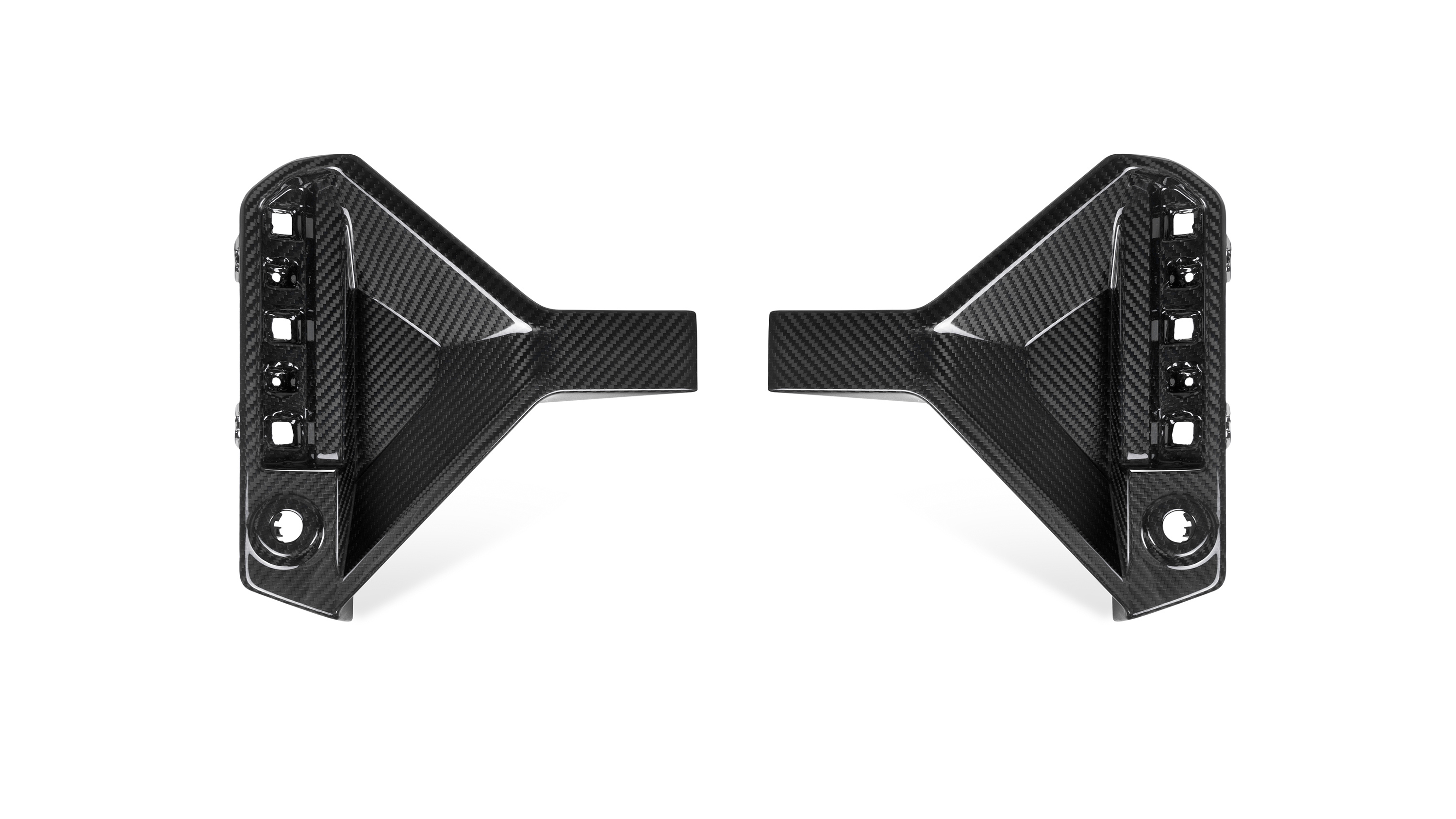 Two carbon fiber car parts, symmetrically placed facing each other, with multiple cut-out sections and glossy surfaces, set against a plain white background.