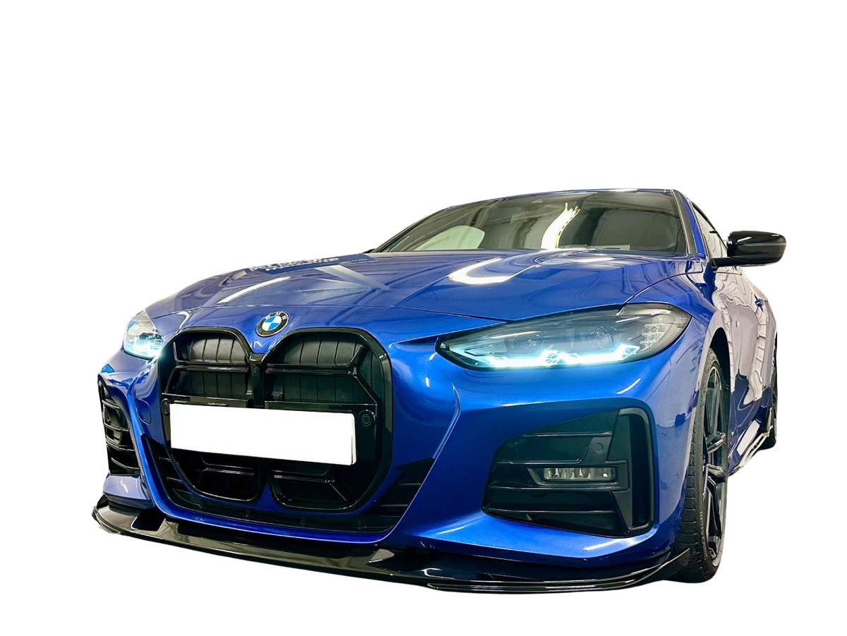 A blue BMW car is parked on a reflective surface, showcasing its sleek design and illuminated headlights. The background is a plain, dark setting, highlighting the vehicle's features.