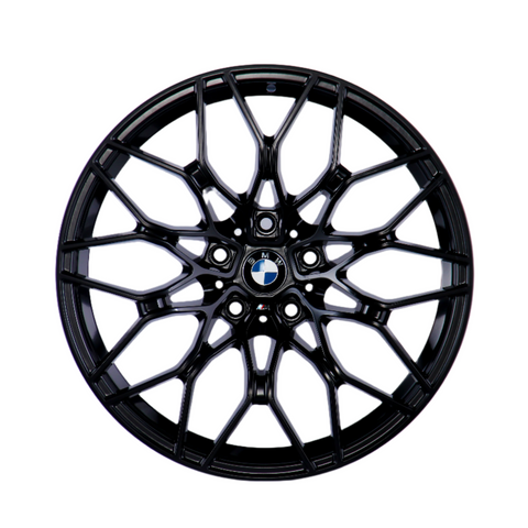 A black, multi-spoke alloy wheel with a central BMW logo, displayed against a plain white background, showcasing intricate design and structure.