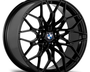 A black, intricately designed car wheel rim with BMW logo in the center, displayed on a plain white background.
