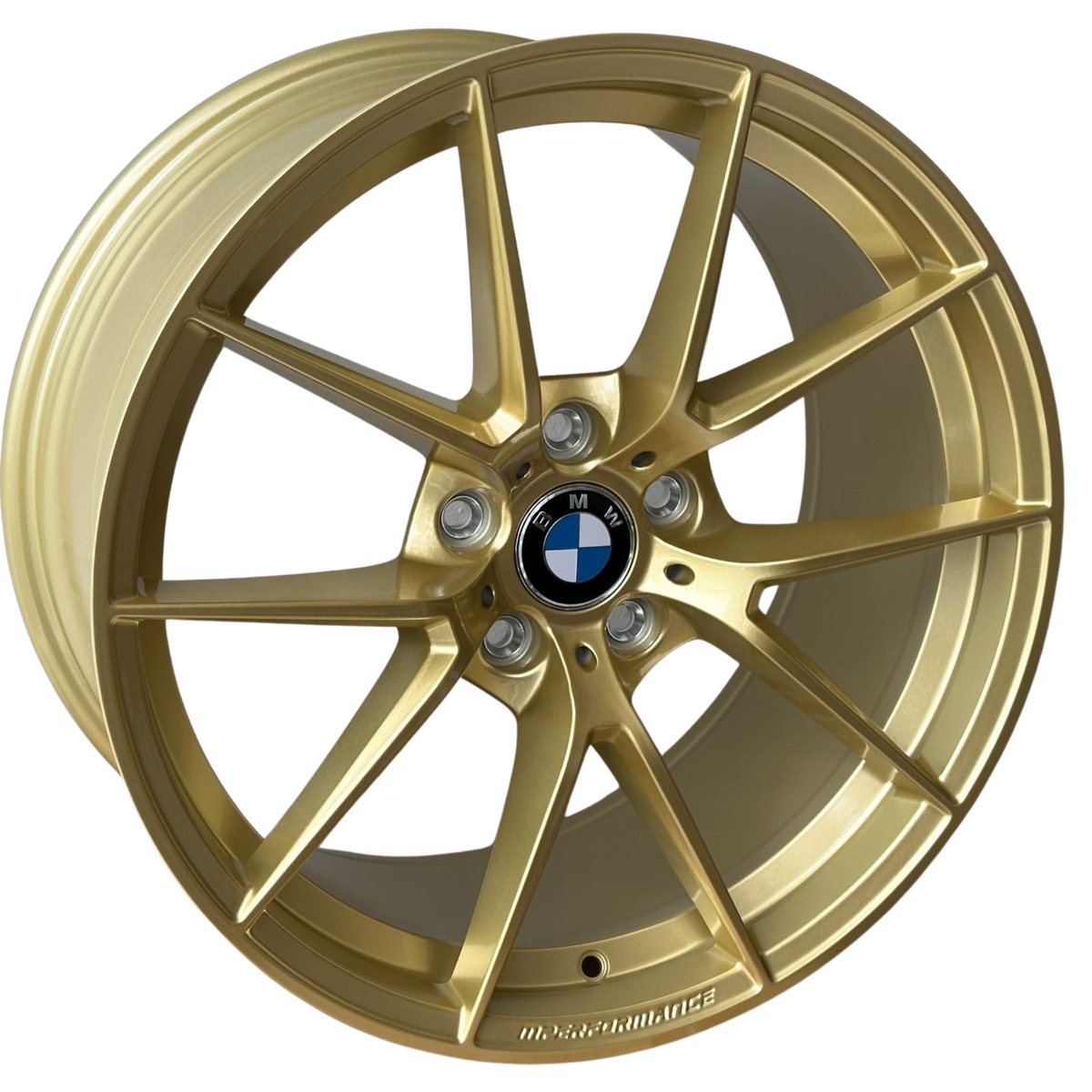 A gold alloy wheel, featuring a five-spoke design, displays a BMW emblem at the center. Raised text near the rim edge reads "M PERFORMANCE." The wheel is isolated on a plain background.
