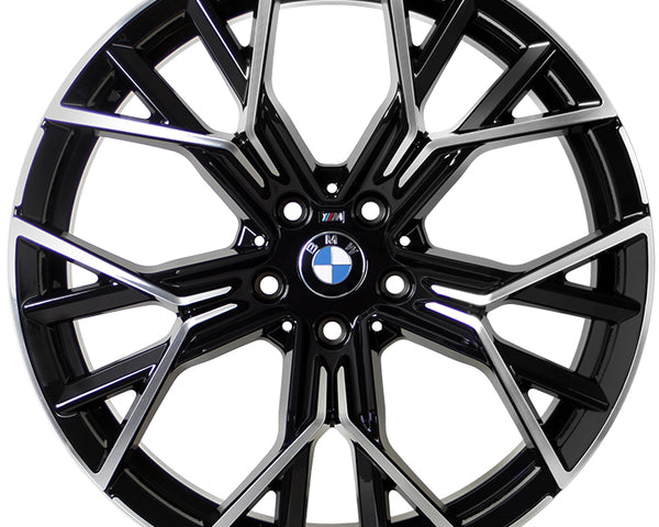 A metallic, multi-spoke alloy wheel with BMW logo at the center, designed for vehicles, displayed against a white background. The spokes feature a black and silver finish with intricate angles.