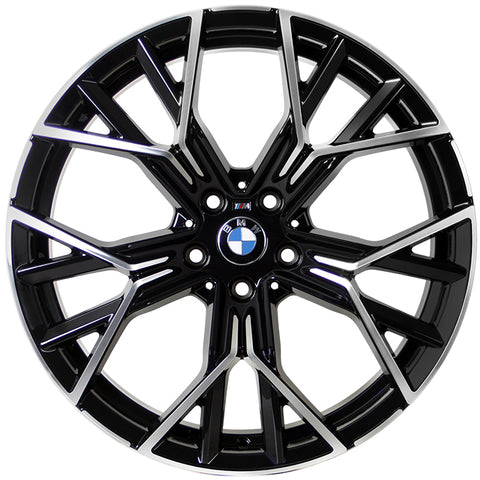 A metallic, multi-spoke alloy wheel with BMW logo at the center, designed for vehicles, displayed against a white background. The spokes feature a black and silver finish with intricate angles.