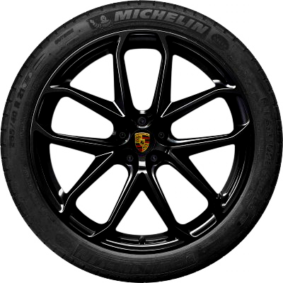 A black car wheel with a multi-spoke rim featuring the Porsche logo in the center. The tire reads "MICHELIN" along the top edge. The background is neutral.