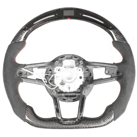 A steering wheel with an exposed interior structure, featuring carbon fiber details and a digital display at the top. The wheel is set against a plain white background.