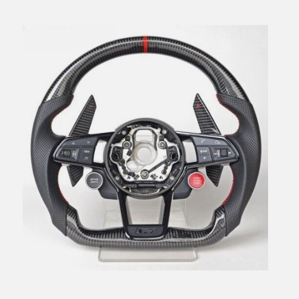 A carbon fiber car steering wheel, with multiple buttons including “VIEW” and “MENU” on the left and “RES” on the right, is displayed on a stand with a minimal background.