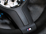 Steering wheel, featuring a carbon fiber insert and 