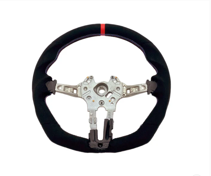 A steering wheel with a black, fabric-covered rim and a red stripe at the top, features a metallic core with attachment points, against a plain white background.