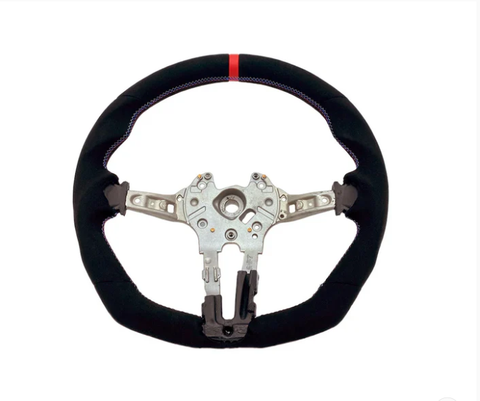 A steering wheel with a black, fabric-covered rim and a red stripe at the top, features a metallic core with attachment points, against a plain white background.