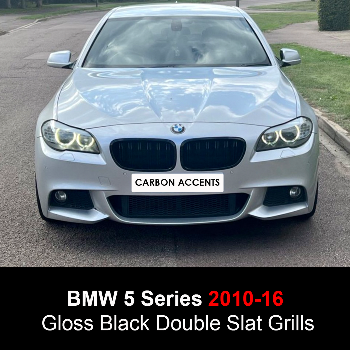 A BMW 5 Series car with illuminated headlights is parked on a street. The front grille features "Carbon Accents." Text reads: "BMW 5 Series 2010-16 Gloss Black Double Slat Grills."