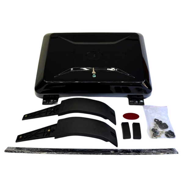 A black rectangular bike trunk lid with hinges sits surrounded by accessory parts: two curved brackets, a strip, and a bag of screws on a white background.