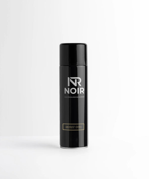 A black cylindrical deodorizer canister labeled "NR NOIR HIGH PRESSURED DEODORISER" with the scent "GREAT OUD," stands upright on a white surface against a plain backdrop.
