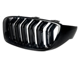 A glossy black car grille features vertical slats with a chrome finish, against a plain white background, designed for the front of a vehicle.