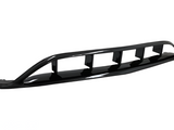 A glossy black car rear diffuser with four vertical fins, designed for aerodynamic efficiency, sits against a plain white background.
