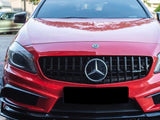 A red Mercedes-Benz car, viewed from the front, is parked. It features a prominent grille with the Mercedes emblem. Other cars and greenery are visible in the background.
