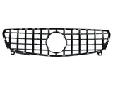 A black car grille with vertical and horizontal bars forms a grid pattern, featuring a circular center frame, set against a plain white background.