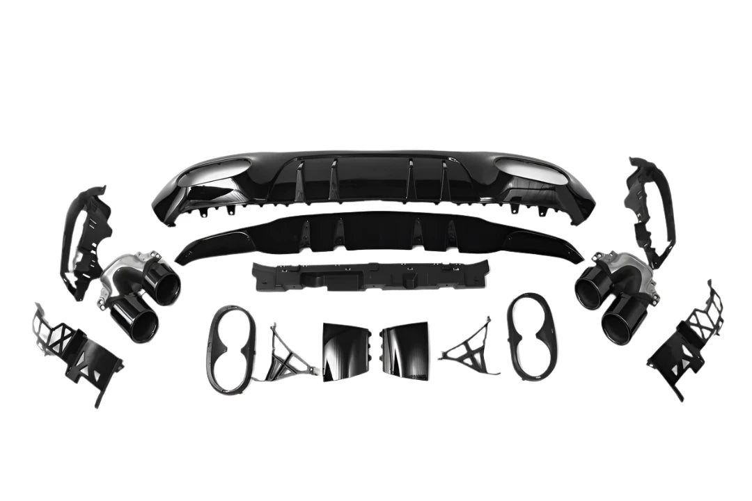 Car bumper assembly kit, showing multiple black and silver parts arranged symmetrically, including fender pieces and exhaust tips, isolated on a white background.