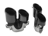 Black dual exhaust tips sit on a white background, featuring a glossy finish with mounting brackets attached, designed for vehicle exhaust systems.