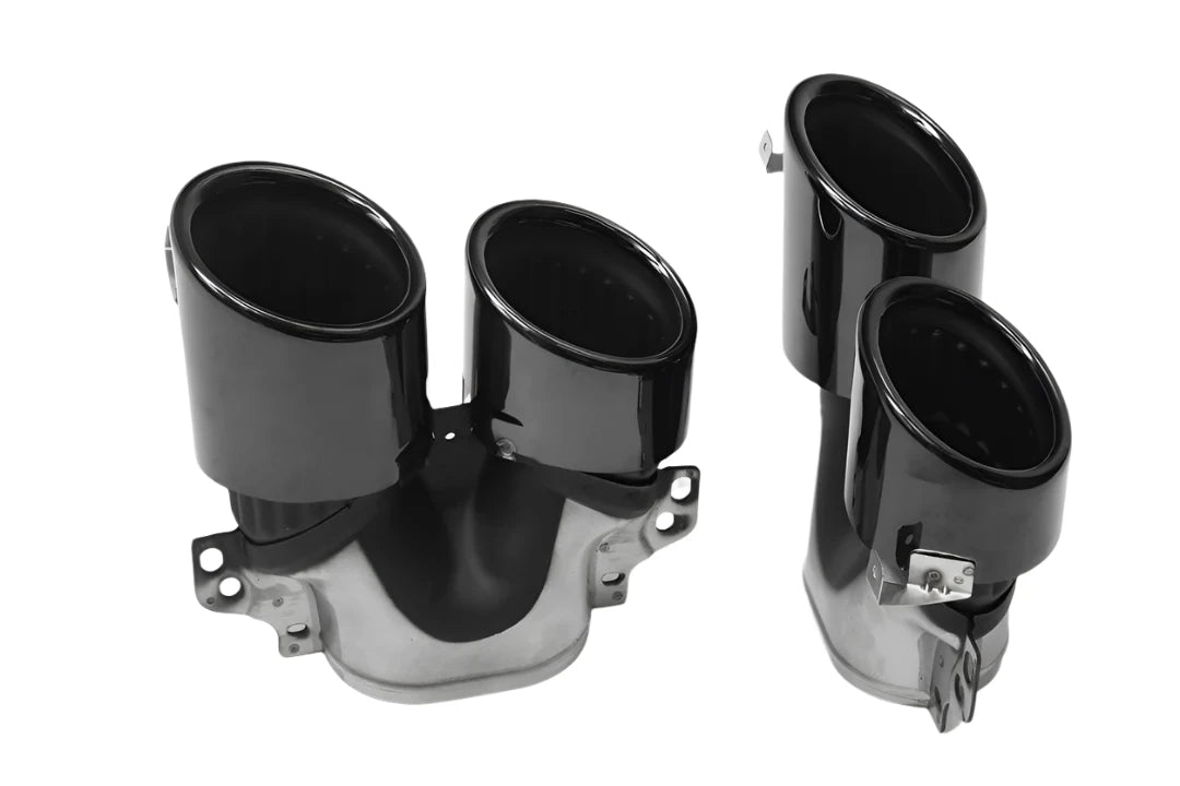 Black dual exhaust tips sit on a white background, featuring a glossy finish with mounting brackets attached, designed for vehicle exhaust systems.