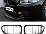 A black BMW car displays its front grille with a license plate reading 