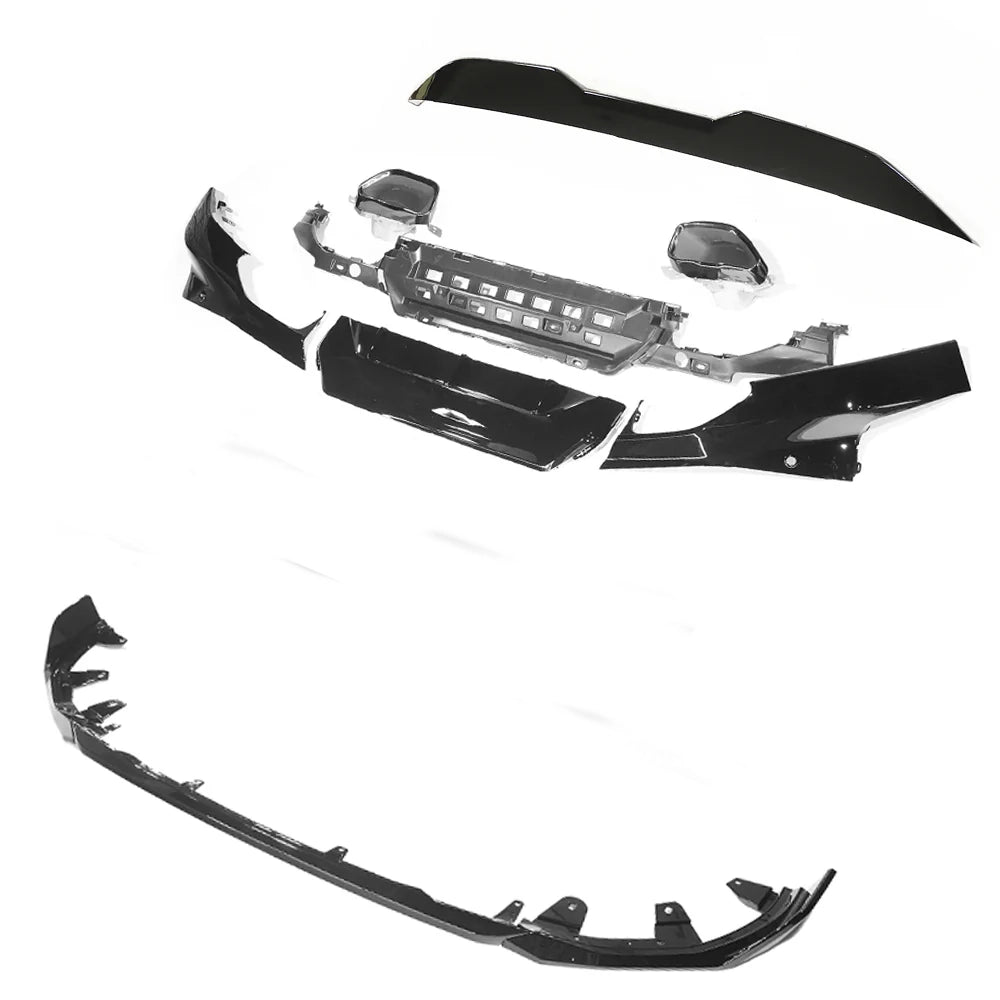 Car bumper kit with various black components, including a grille and trim pieces, spread out on a white background.