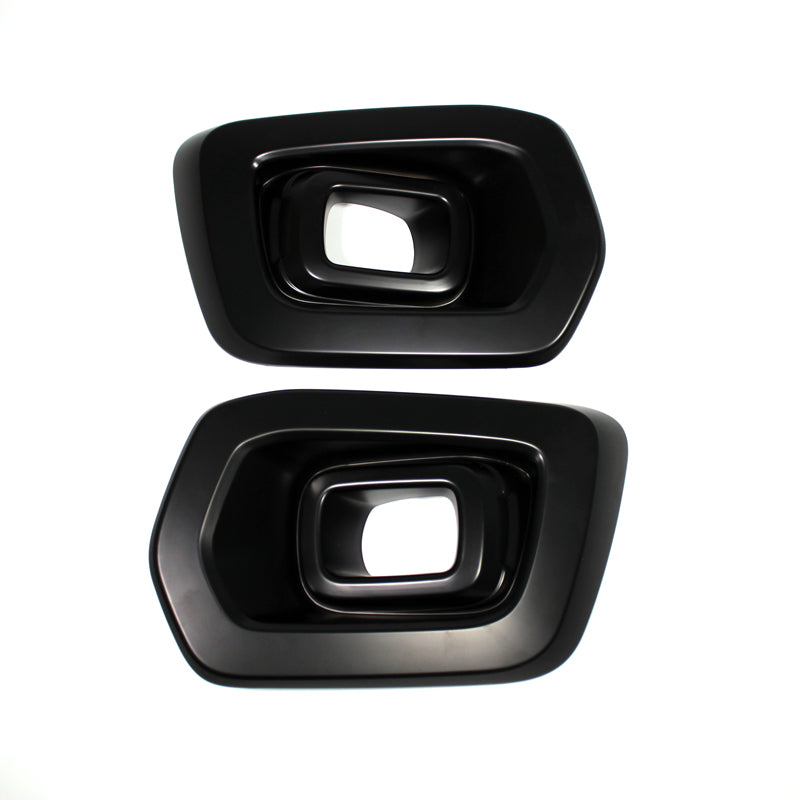 Two black, rectangular exhaust tip covers with beveled edges, placed side by side on a white background, showing their hollow interior.
