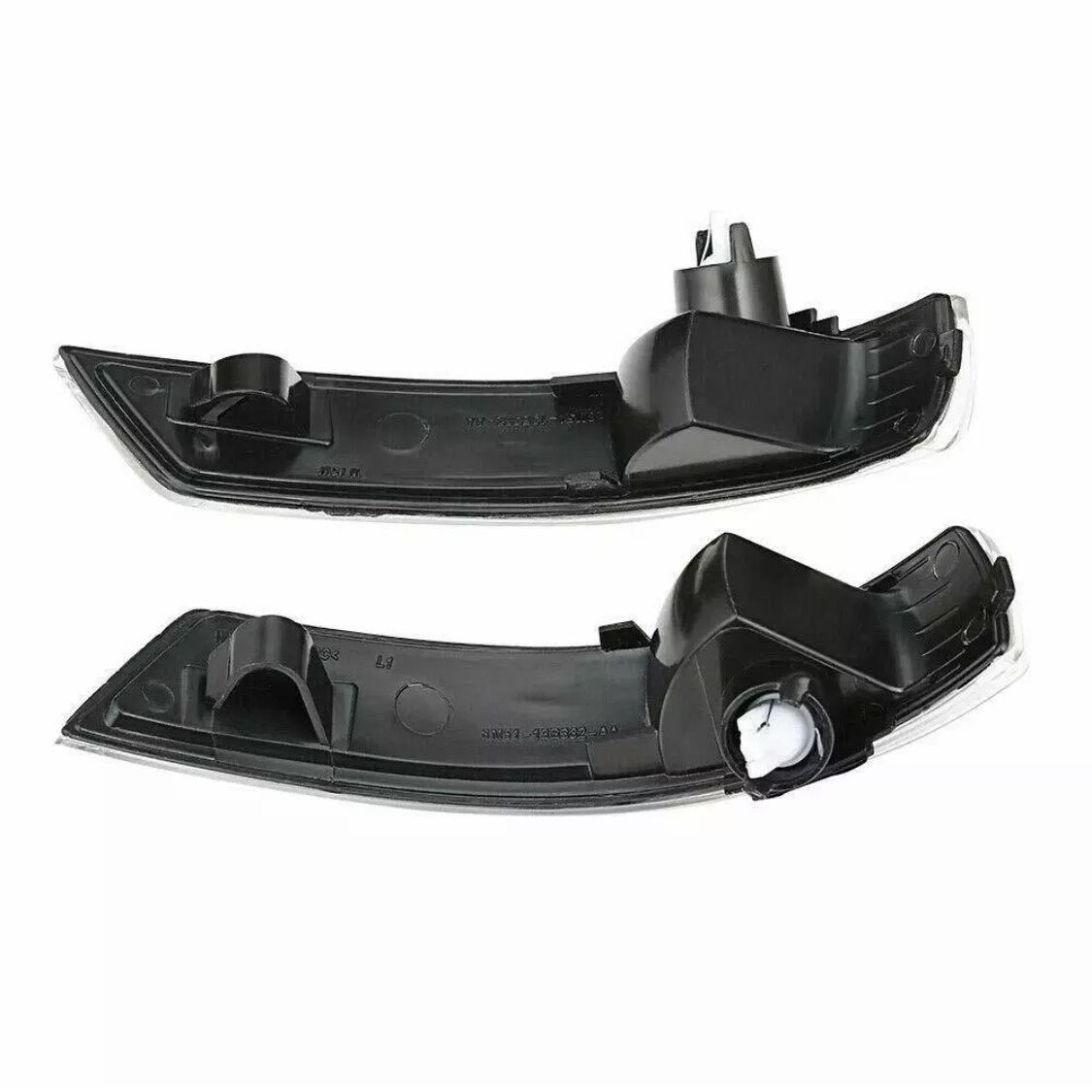 Two black plastic car light covers, each with a curved shape and mounting points, are positioned horizontally on a white background.