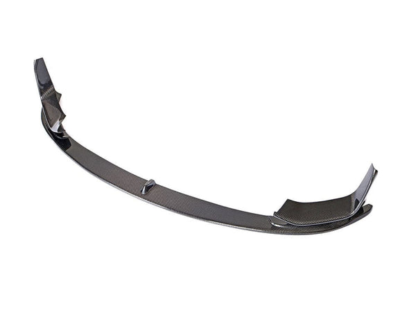 A carbon fiber car front lip spoiler is shown, arched with winged ends, designed to enhance aerodynamics. It's isolated on a plain white background.