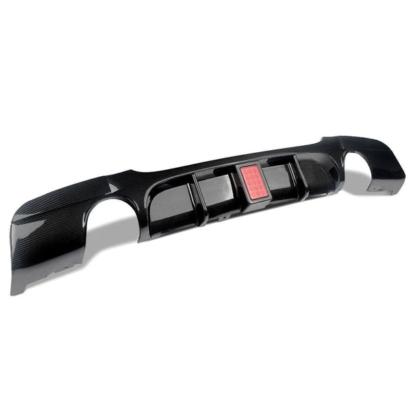 A carbon fiber car bumper diffuser with a rectangular red light is displayed on a white background, showcasing its glossy finish and aerodynamic design.