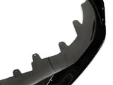 A black car front splitter, featuring multiple mounting tabs, is shown in close-up on a white background, highlighting its glossy finish and aerodynamic design.