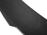 A carbon fiber panel, weaving patterns visible, reflects light subtly, showcasing its glossy surface. The background is plain white, highlighting the sleek, textured design.