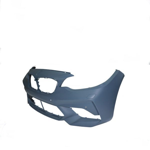 A blue-grey car bumper is displayed on a plain white background. It features openings for the grille and lights, with smooth contours for aerodynamics. No text is present.