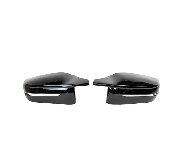 Two sleek, black side mirror covers are aligned symmetrically, facing inward, against a plain white background.