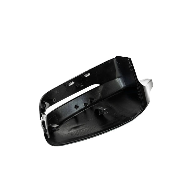 A black plastic car side mirror cover, facing upward, with internal attachment points, isolated on a plain white background.