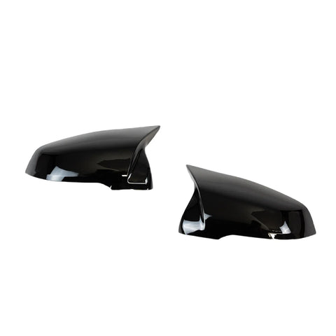 Two glossy black side mirror covers are displayed against a plain white background, angled toward each other, reflecting light on their smooth surfaces.