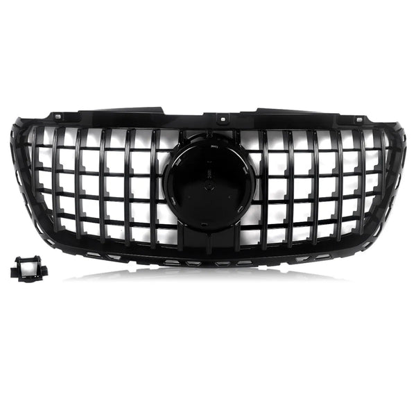 A black car grille features a grid design with a central circular emblem area, set against a white background. A detached rectangular component is located in the lower left corner.
